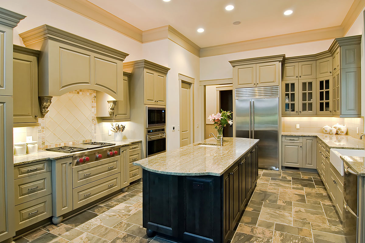 Custom kitchen with gray cabinetry, large island, and pendant lighting
