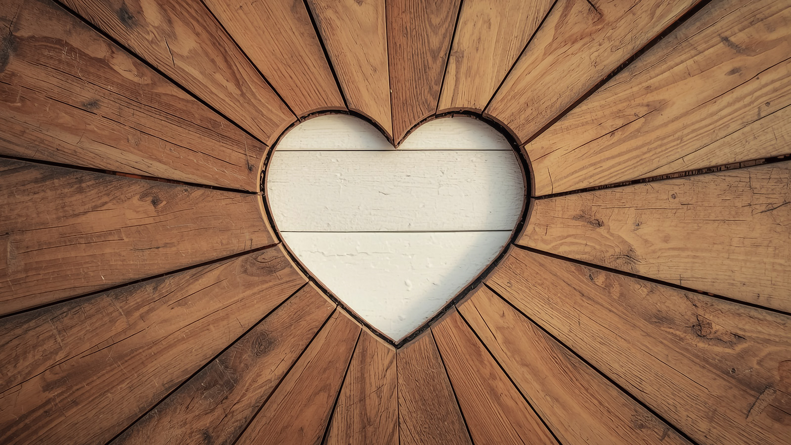 Wood heart representing KATLOW Remodeling’s relationship-first approach.